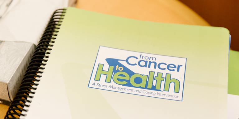notebook with label that reads from cancer to health