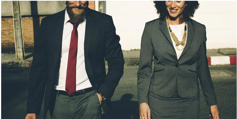 man and woman in business suits walking